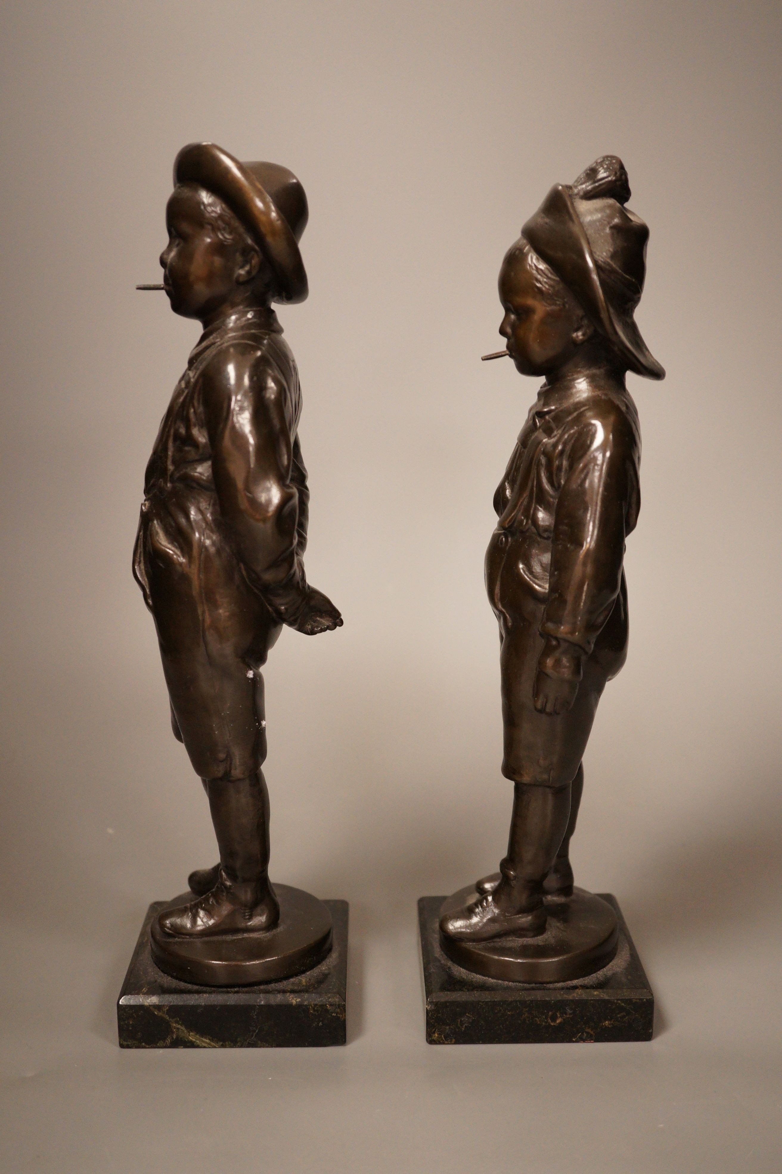 A pair of 20th century patinated metal figures of ruffians, marble bases, tallest 30cm